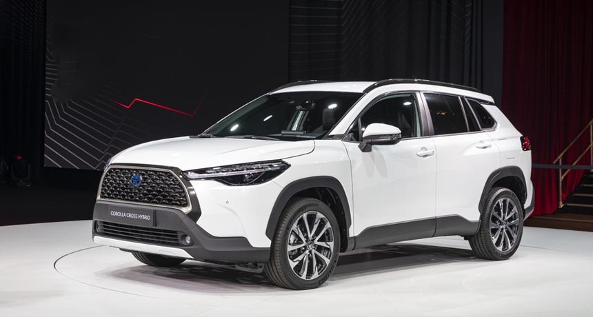Silver Toyota Corolla Cross 2026 crossover SUV parked, showing its bold grille and LED headlights.